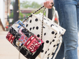 girl carries handbags she purchased from luxury garage sale