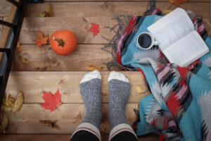 cozy socks embrace fall weather with pumpkins and coffee