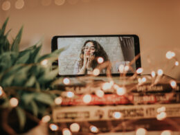 Woman on FaceTime with string lights surrounding phone