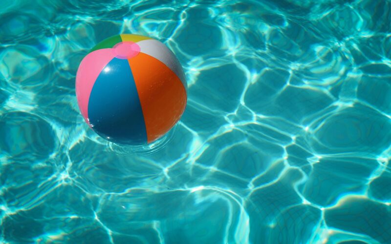 beach ball sits in pool